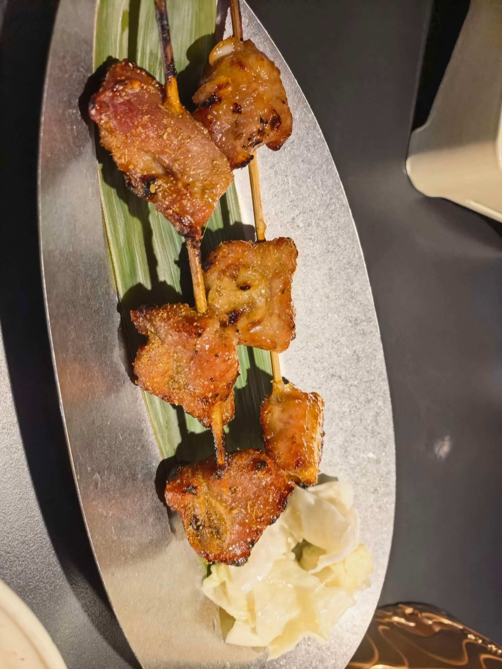 Honey-glazed grilled pork ribs on a decorated plate at a Liuzhou restaurant