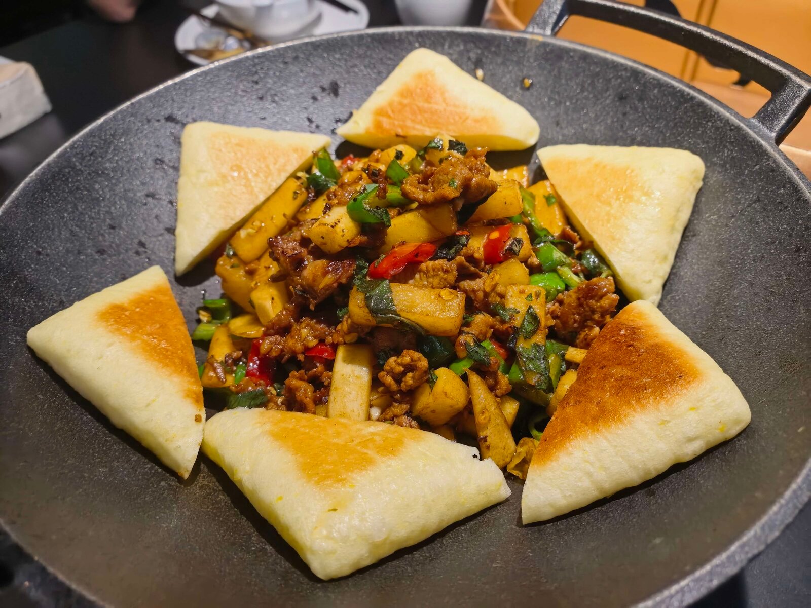 Stir-fried beef with pickled radish and perilla leaf served with fried bread on a hot plate