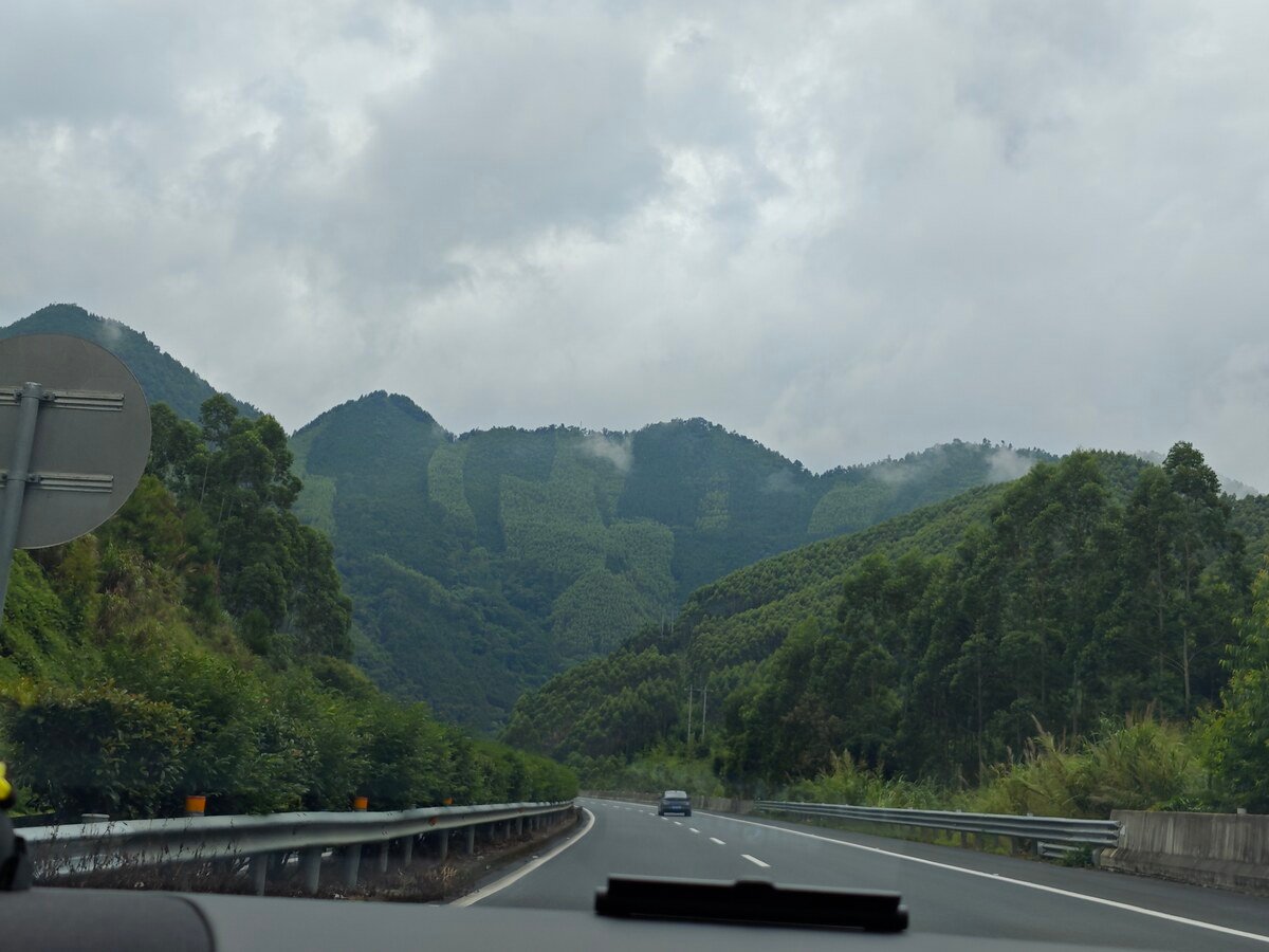 Highway winding through misty green mountains in Guangxi, China