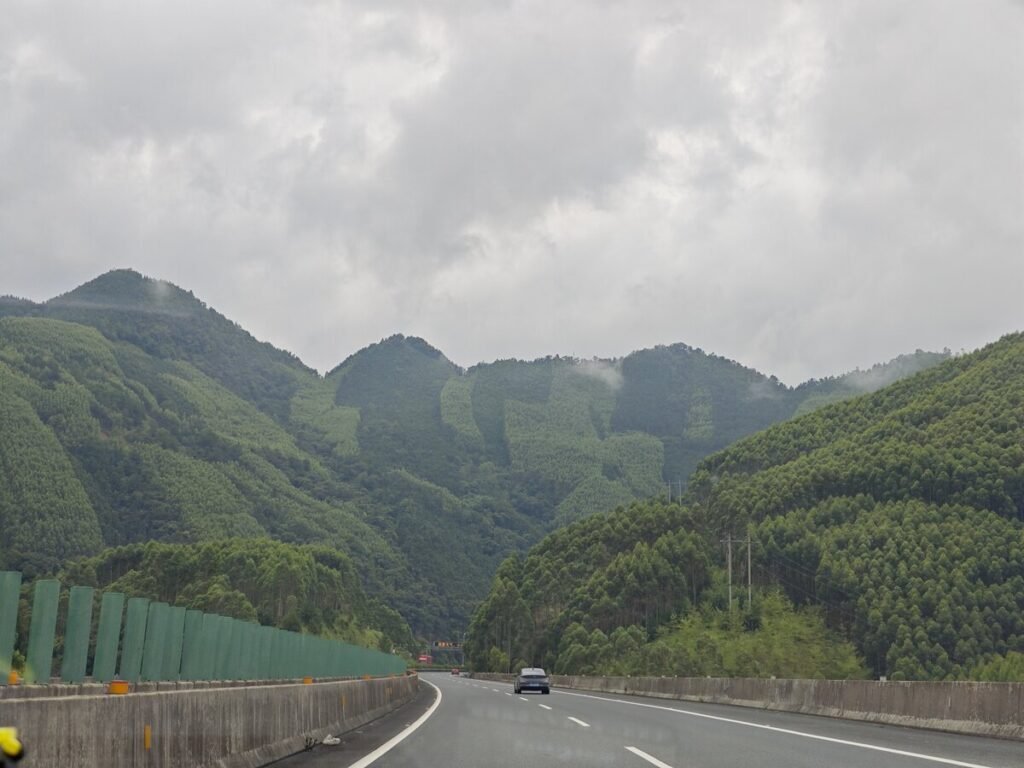 Green karst hills flanking the expressway in Guangxi