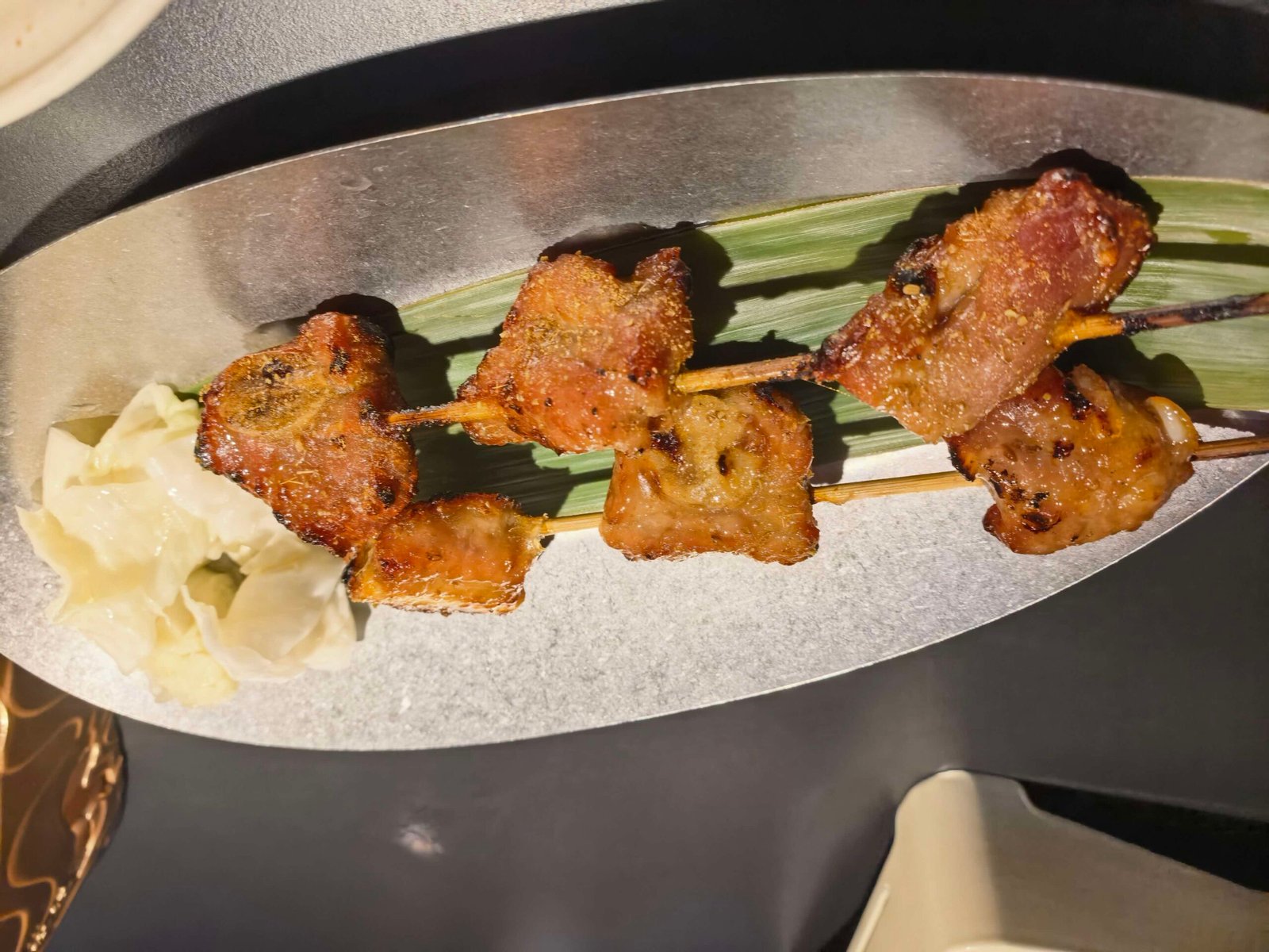Honey-glazed grilled pork ribs on a decorated plate at a Liuzhou restaurant